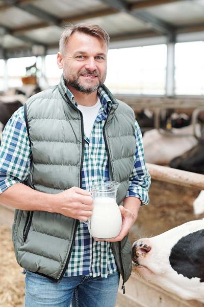 happy-young-worker-of-dairy-farm-holding-jug-with-resize.jpg